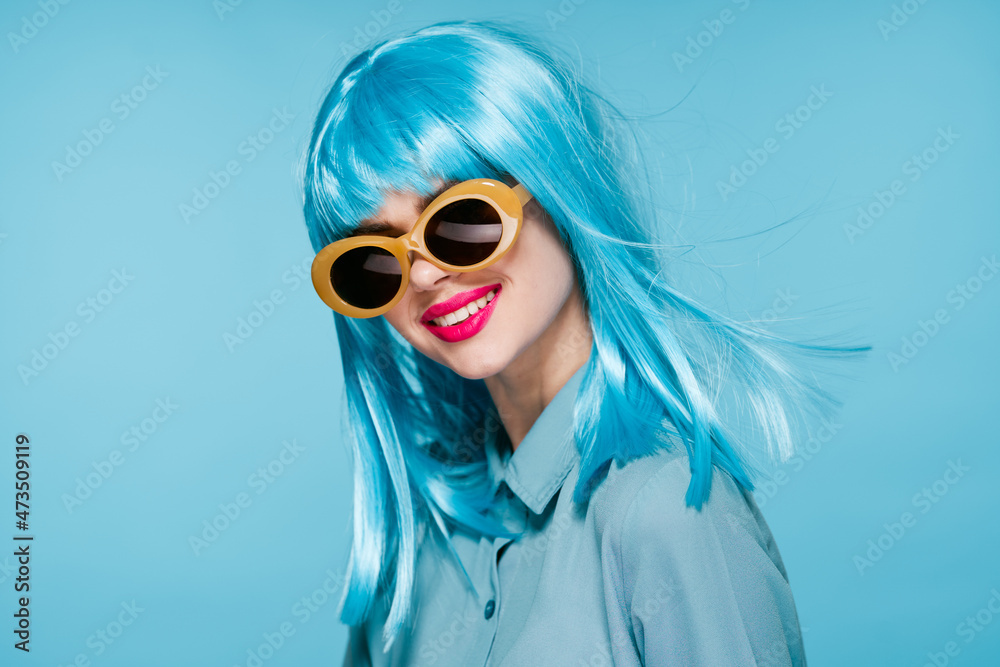 joyful woman purple wig fashion glasses hand gestures blue background