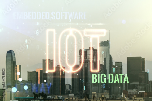 Double exposure of abstract virtual IOT hologram on Los Angeles city skyscrapers background, research and development concept