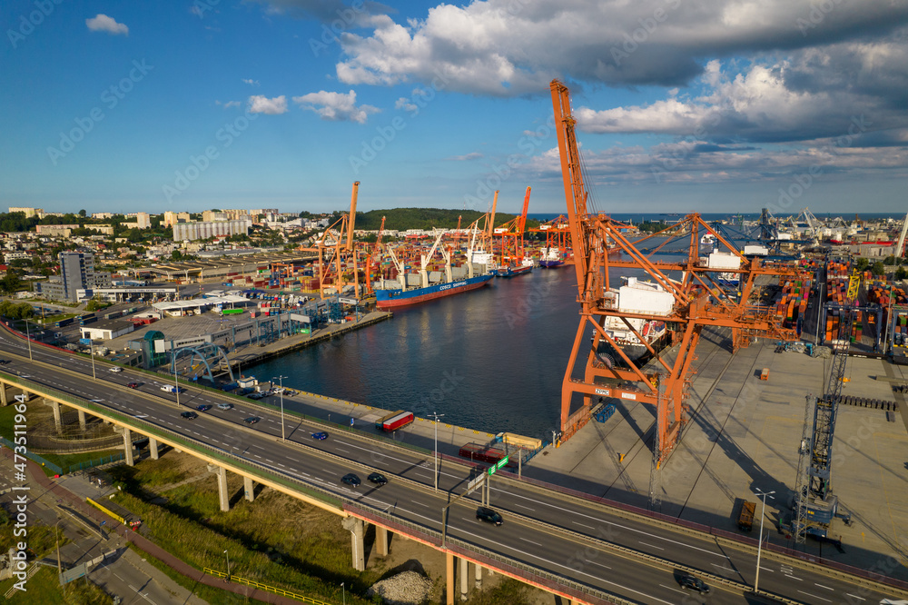 Port of Gdynia. Seaport, containers, container ships and sea transport from the bird's eye view on a sunny day.