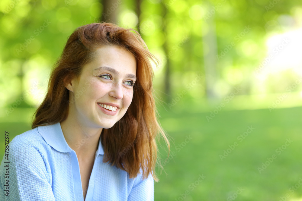 Beautiful happy woman looking away in a park Beautiful happy woman looking away in a park