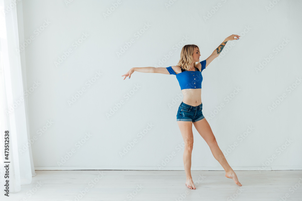 beautiful athletic blonde woman dancing to music alone