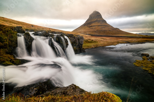 long exposure picture of Kirkjufellsfoss waterfall with dramatic sky silky water © Hang Loose Marketing