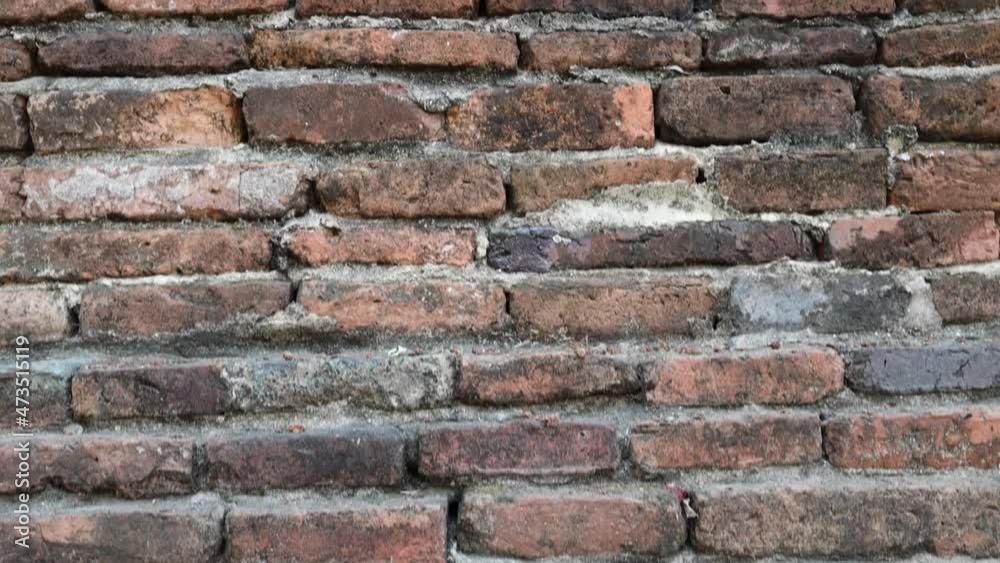 Dingy old threadbare brick wall. Camera slowly moving upwards. Dingy old threadbare brick wall. Camera slowly moving upwards.
