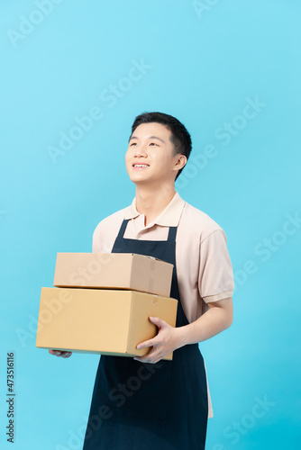 Asian smart handsome male cafe and bakery business owner, holding boxes for delivery bread to customers