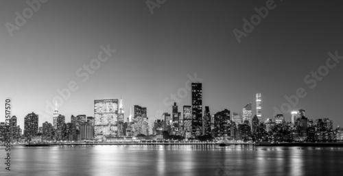 Black and white panoramic view of the skyline of midtown Manhattan in New York by night