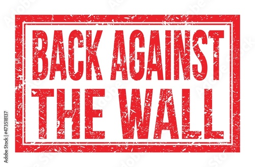 BACK AGAINST THE WALL, words on red rectangle stamp sign