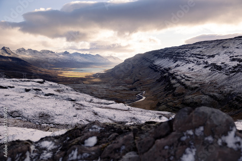 Icelandic Highlands in dramatic sunlight and cloudy sky - blurred rock in front 