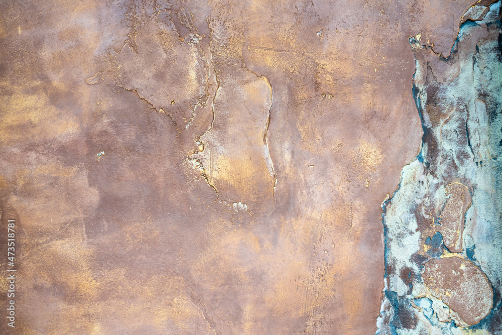 Photo of a pink and blue wall with golden streaks. Interior