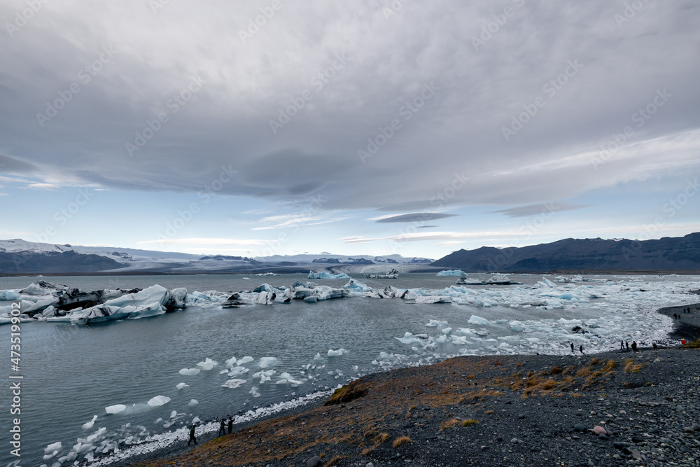 wide angle picture of Jökulsárlón lake with glacier icebergs in the lake and on the shore moody clouds wide angle picture of Jökulsárlón lake with glacier icebergs in the lake and on the shore moody clouds