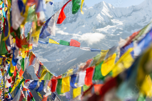Himalayas framed by long strings of colorful Tibetan prayer flags flutter in the wind. Annapurna base camp.