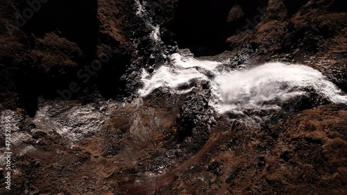 drone over cliffs towards flowing waterfall of rjukandafoss photo