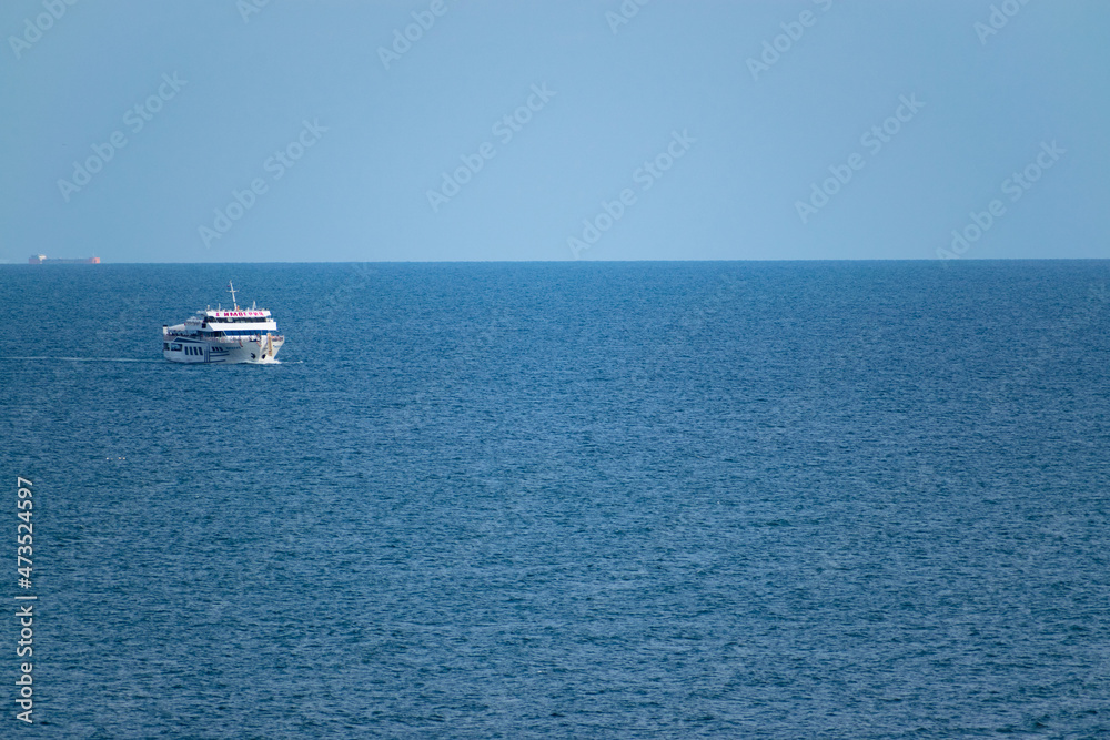 Obraz premium Big ship in blue sea and sky.