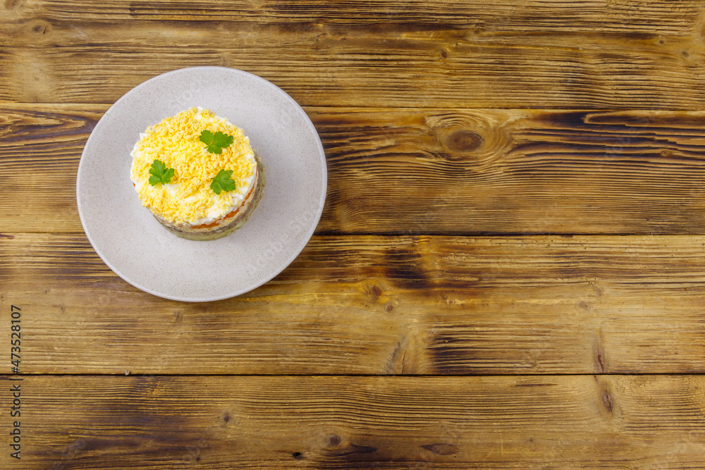 Traditional russian salad Mimosa on wooden table. Top view Traditional russian salad Mimosa on wooden table. Top view