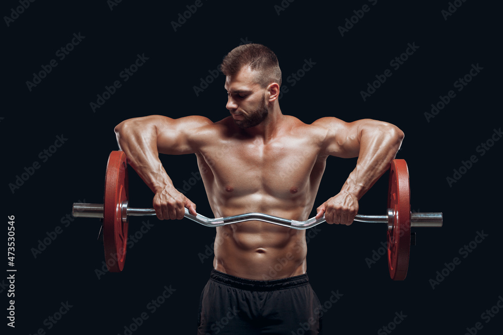Front view of a strong man bodybuilder lifting a barbell isolated on black background Front view of a strong man bodybuilder lifting a barbell isolated on black background
