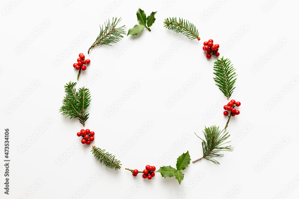 Christmas round frame made from holly berries and green twigs. Christmas round frame made from holly berries and green twigs.