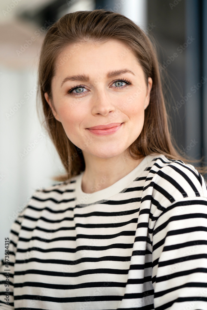 Smiling businesswoman with gray eyes at office Smiling businesswoman with gray eyes at office
