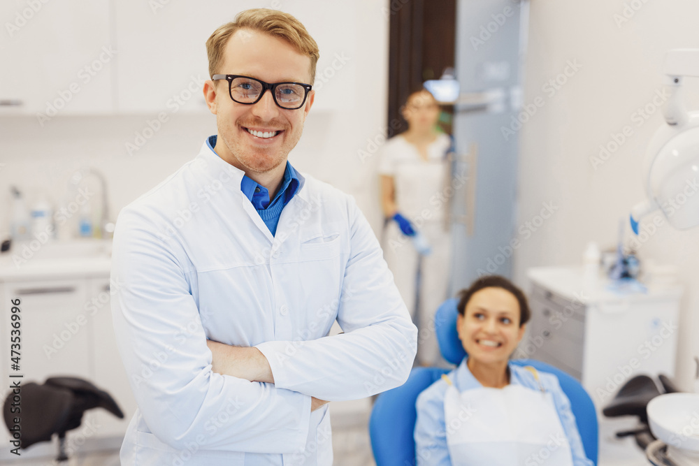 Dentist posing at camera with patient