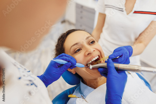 Doctor and nurse doing treatment of woman teeth