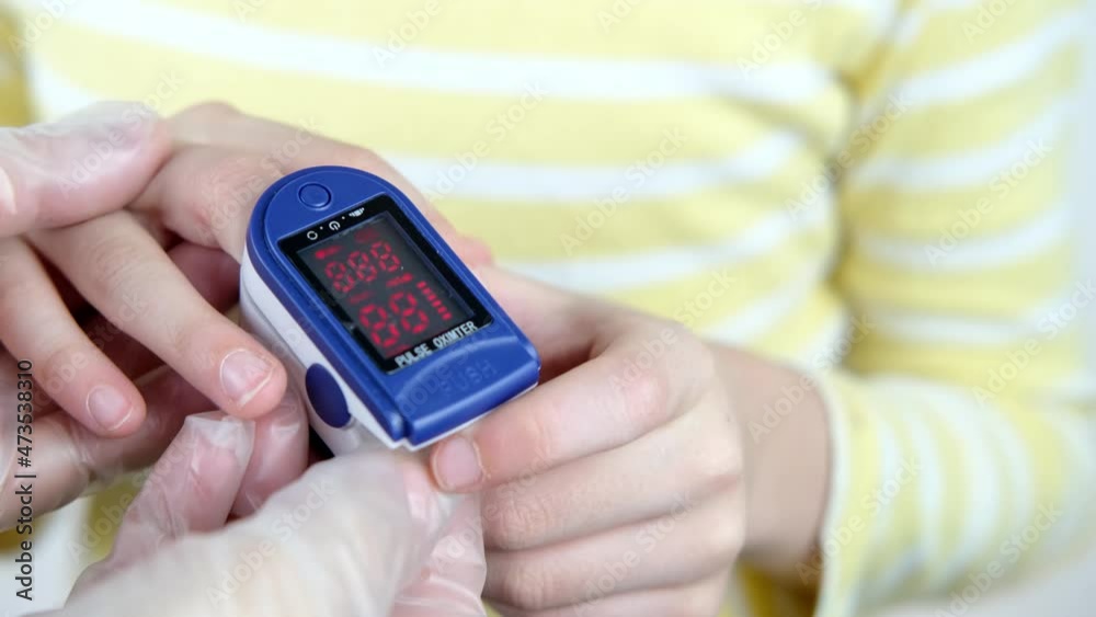 medical device pulse oximeter for measuring oxygen in the blood on child's finger, teenager 10 years old, concept of measuring saturation, blood oxygen saturation, treating people of covid-19 virus medical device pulse oximeter for measuring oxygen in the blood on child's finger, teenager 10 years old, concept of measuring saturation, blood oxygen saturation, treating people of covid-19 virus