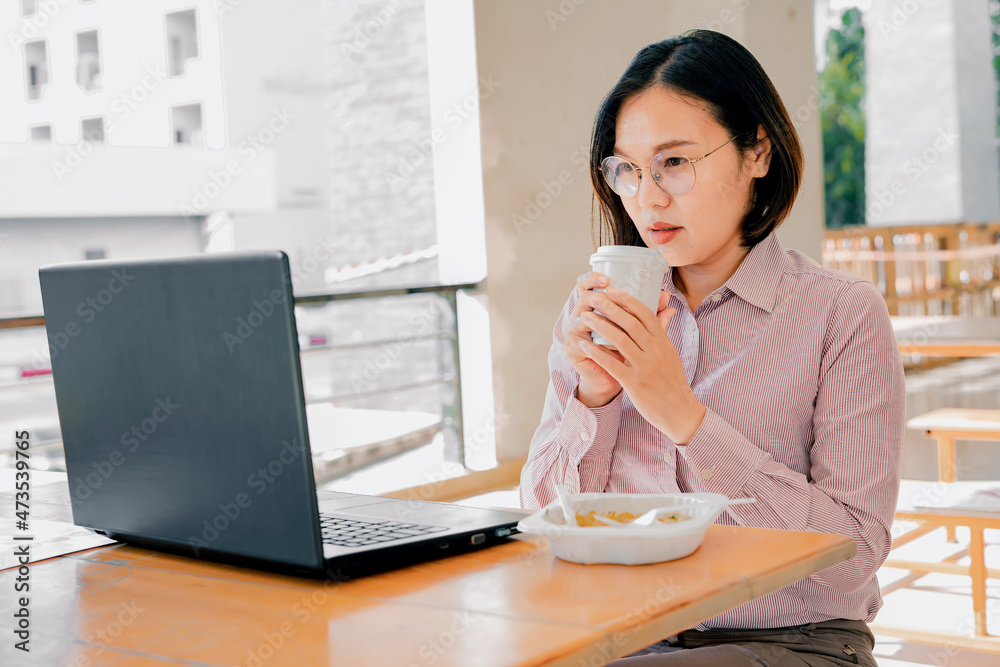 Woman working online through mobile phone and notebook computer. Woman working online through mobile phone and notebook computer.