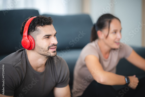 young couple playing fun and happy smile with video game at home, digital device technology © chokniti