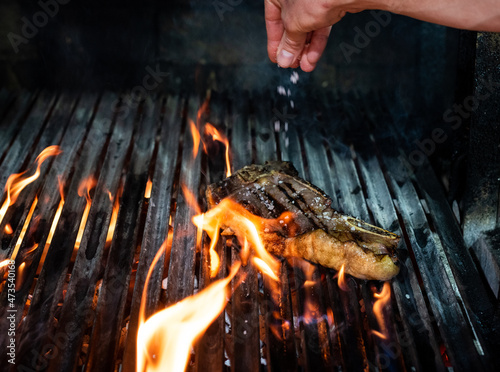 Fototapeta Beef T-bone steak on the grill with flames
