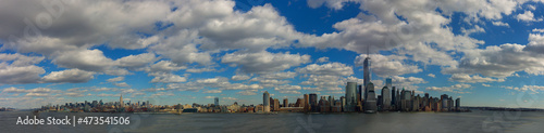 Panoramic view of Manhattan with blue sky and white clouds