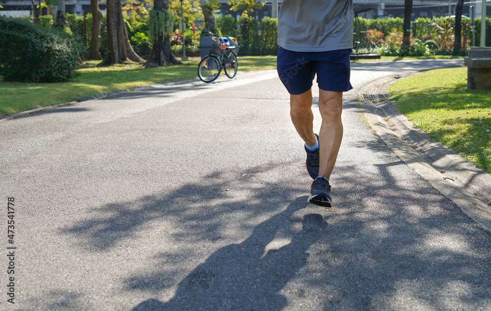 senior man legs running in the park in the morning sunshine.concept older activity lifestyle for health senior man legs running in the park in the morning sunshine.concept older activity lifestyle for health