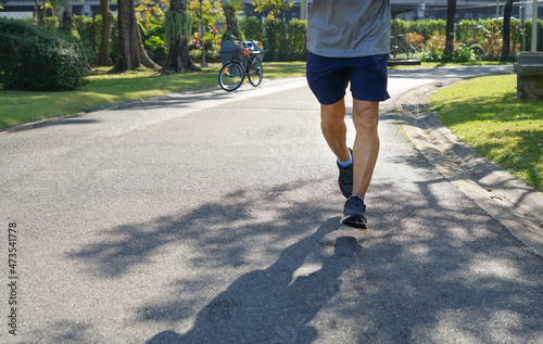 Fototapeta Naklejka Na Ścianę i Meble -  senior man legs running in the park in the morning sunshine.concept older activity lifestyle for health