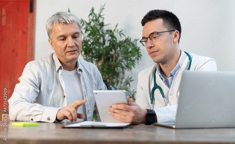 consultation in the clinic doctor age man and patient consultation in the clinic doctor age man and patient