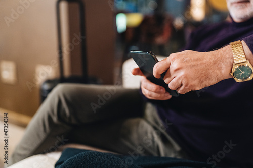 Man using mobile phone at hotel photo