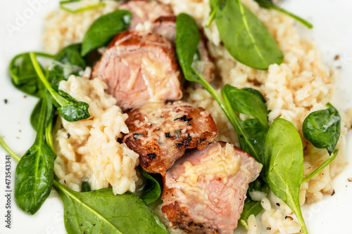 Wallpaper Mural Pork tenderloin medallions on risotto with parmesan and spinach leaf,closeup. Torontodigital.ca
