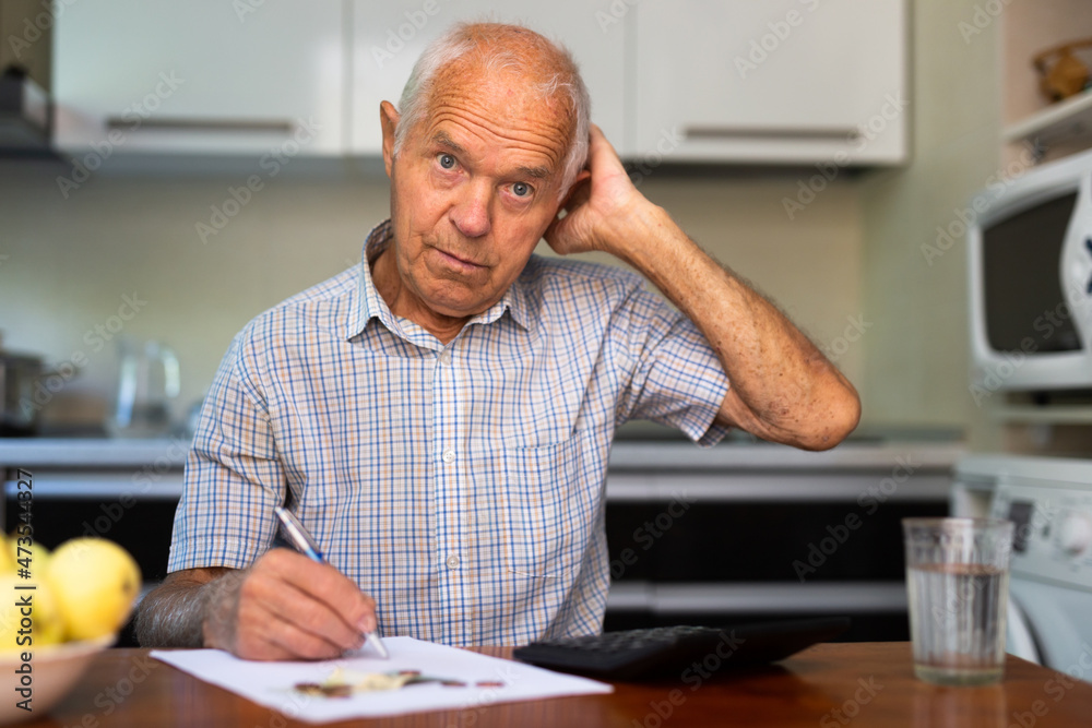 Senior man counting money in the room Senior man counting money in the room