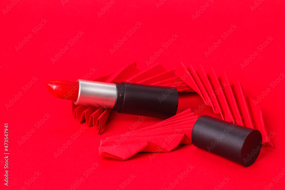 Red lipstick with paper craft on red background. Red lipstick with paper craft on red background.