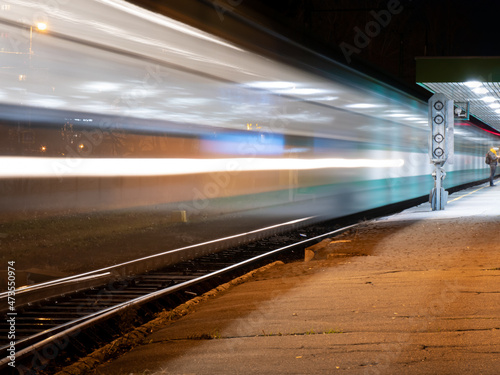 Train in motion on the railway station at night with motion blur effect