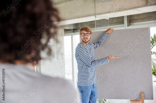 Man wearing eyeglasses holding partition wall at home apartment photo