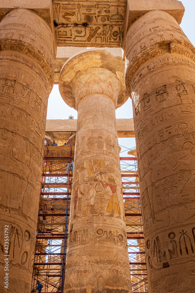 Luxor, Egypt - September 21, 2021: View of the main axis of the Hypostyle Hall with its twelve large columns, and the smaller columns. Luxor, Egypt - September 21, 2021: View of the main axis of the Hypostyle Hall with its twelve large columns, and the smaller columns.