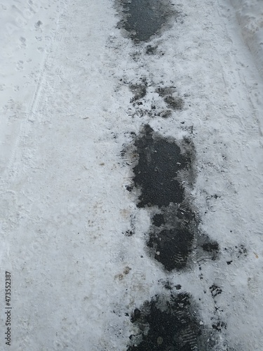 Asphalt path with melted snow close-up. High quality photo © Varvara