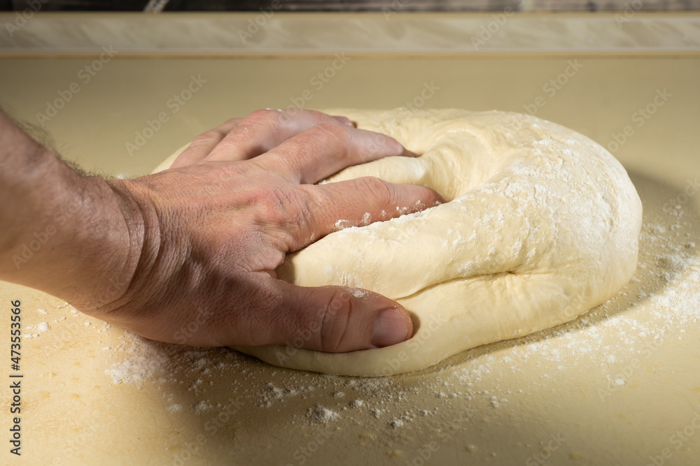 Fototapeta premium preparing the dough with your hands for baking