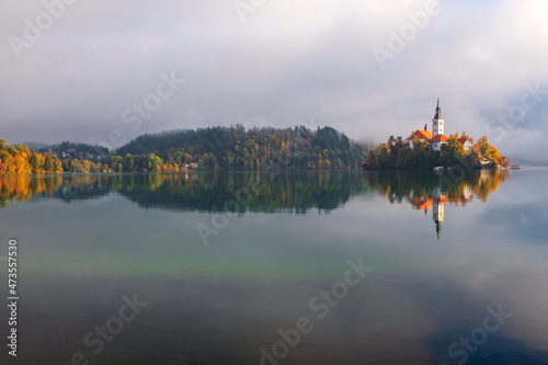 Autumn misty landscape at Lake Bled, in the middle of the lake with the church on it, in the Julian Alps, Triglav National Park