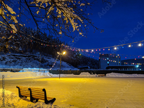 Bench with a view of the night skating rink, Belokurikha, Altai, Russia photo