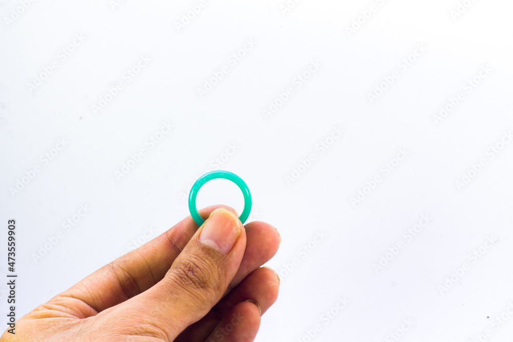 Green full jade ring in hand on an isolated white background.