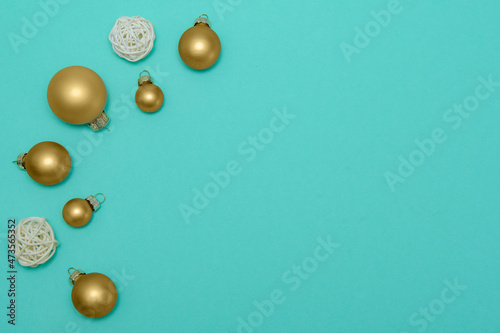 Green background with gold balls. New Year's decoration. Background. Christmas. Spruce.