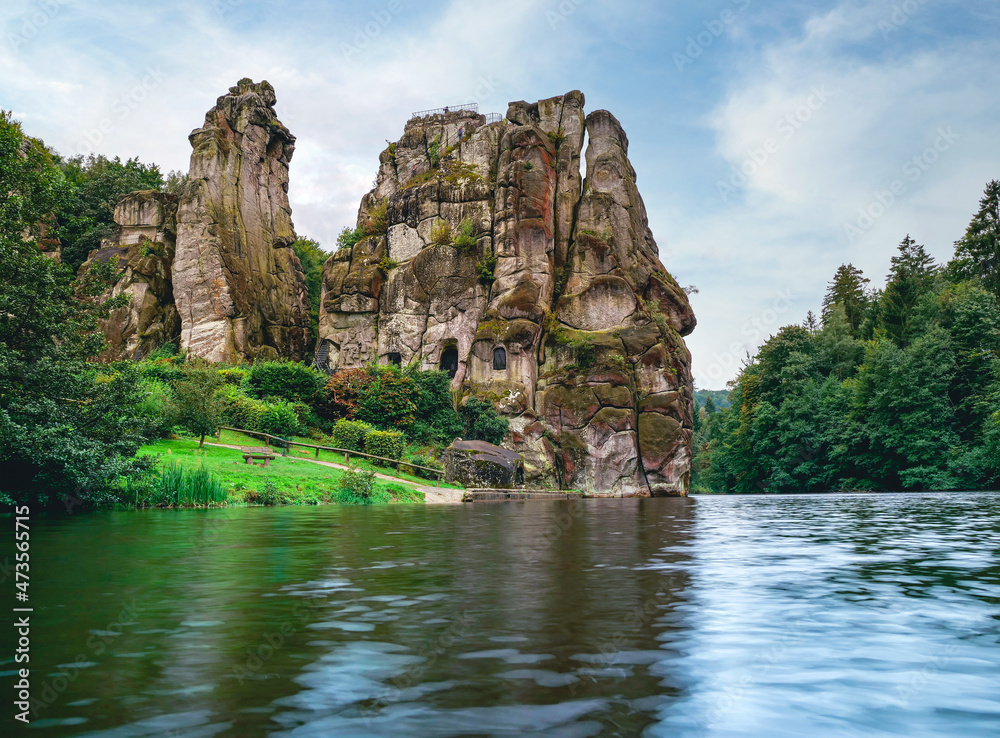 Externsteine in the Teutoburg Forest in Germany. Travel and sights of city breaks. landmarks, travel guide Europe. Banner or panoramic postcard