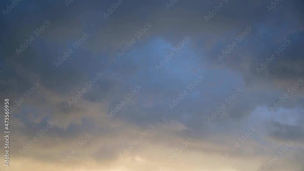Timelapse of the sky. Gray clouds are moving in the sky. The blue sky looks through the gray clouds. Timelapse of the sky. Gray clouds are moving in the sky. The blue sky looks through the gray clouds.