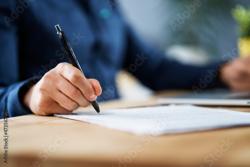 Businessman signing documents while working from home photo