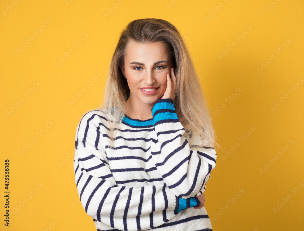 Smiling gorgeous young woman looking at camera, isolated on yellow background. Half length. Pretty girl with positive emotion, smiley expression Smiling gorgeous young woman looking at camera, isolated on yellow background. Half length. Pretty girl with positive emotion, smiley expression