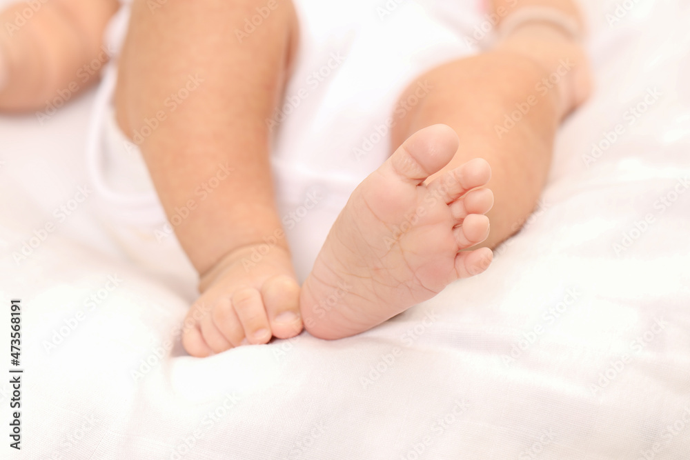 Cute little baby lying on bed, space for text. Banner design Cute little baby lying on bed, space for text. Banner design