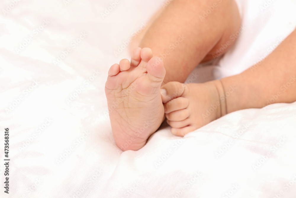 Cute little baby lying on bed, space for text. Banner design Cute little baby lying on bed, space for text. Banner design