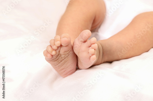 Cute little baby lying on bed, space for text. Banner design